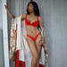 Sonomi Savoy in red lingerie and robe in New York.